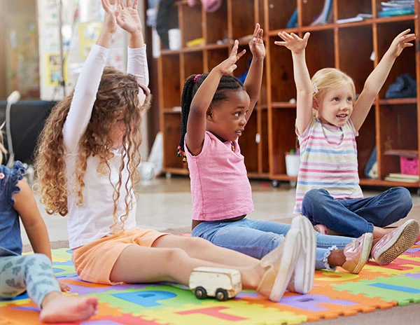 Children participating in a classroom movement activity